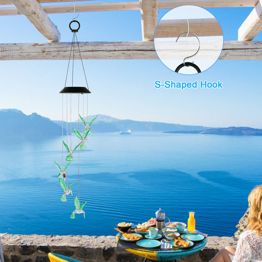 Solar hummingbird chime light color transition from warm to cool tones at night