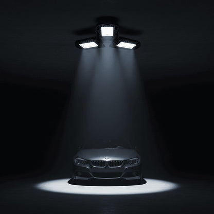 LED garage light casting bright white light downward in dark garage at night