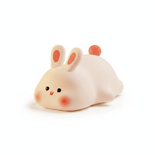 Cute bunny LED night light on white studio background with soft warm glow