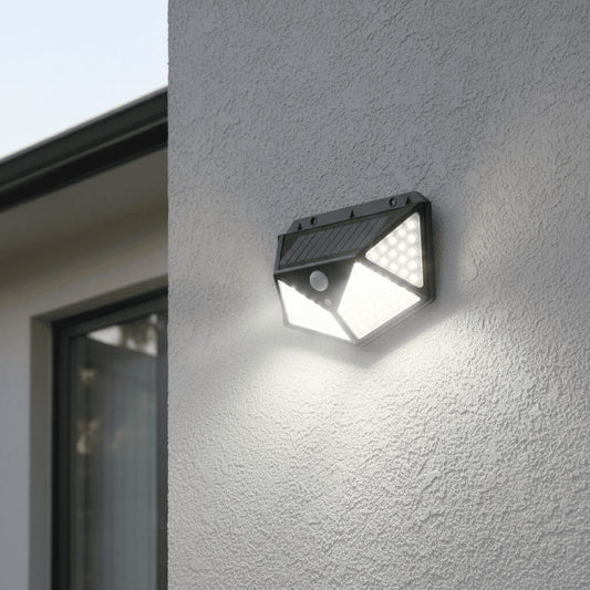 Solar PIR wall light mounted on exterior wall at night with motion-activated bright illumination