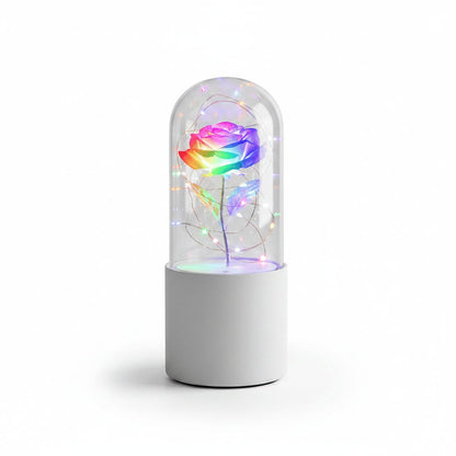 Rose LED night light with white base and multicolor flower on white background